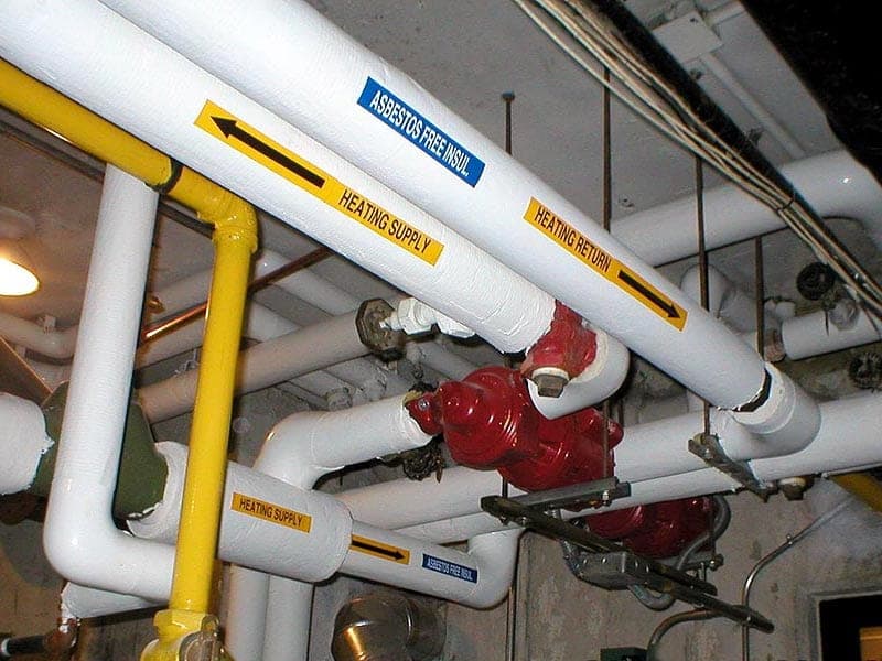 Insulated heating pipes in a commercial mechanical room